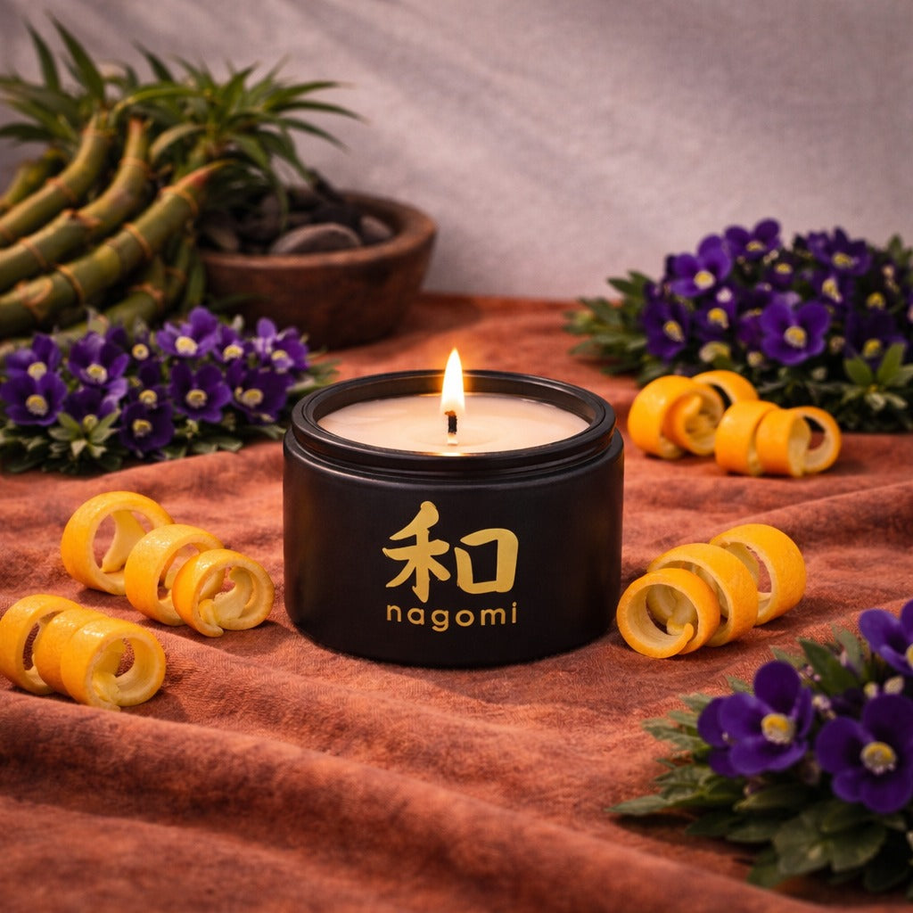 4 oz Nagomi Bamboo Breeze candle in a black glass container with orange peels, bamboo stalks and African violets
