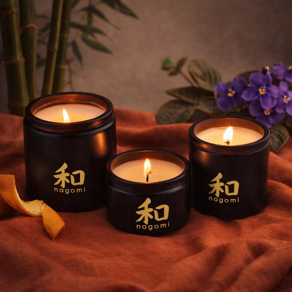 3 Nagomi Bamboo Breeze candles in Black glass containers with orange peels, bamboo stalks and African violets