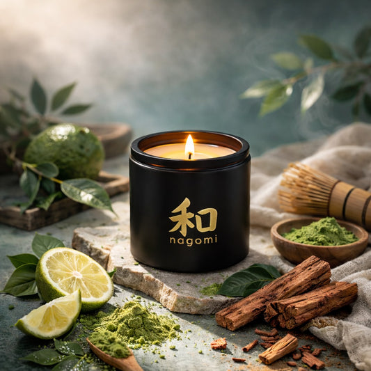 Eight-ounce Nagomi Aromatic Journey candle in a black glass jar, lit, on a neutral background with bergamot, matcha, and sandalwood.