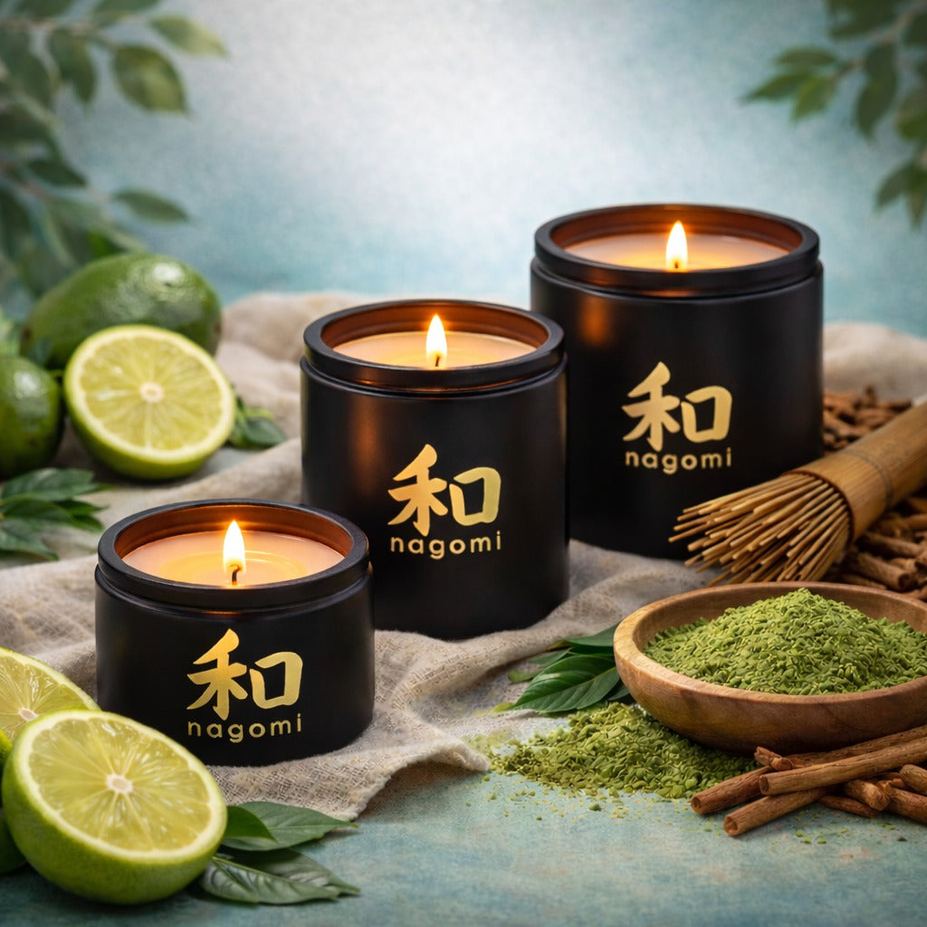 Three Nagomi Aromatic Journey candles in black glass jars, lit, on a neutral background with bergamot, matcha, and sandalwood.