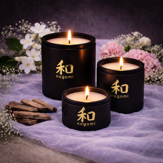3 Nagomi Mystic Alchemy candles in black jars with Jasmine, geranium and teakwood in the background